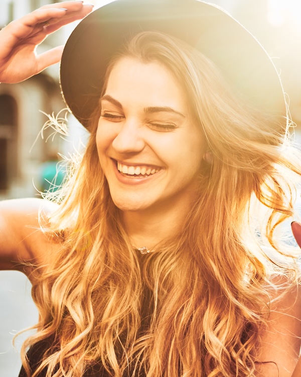 woman with hat smiling